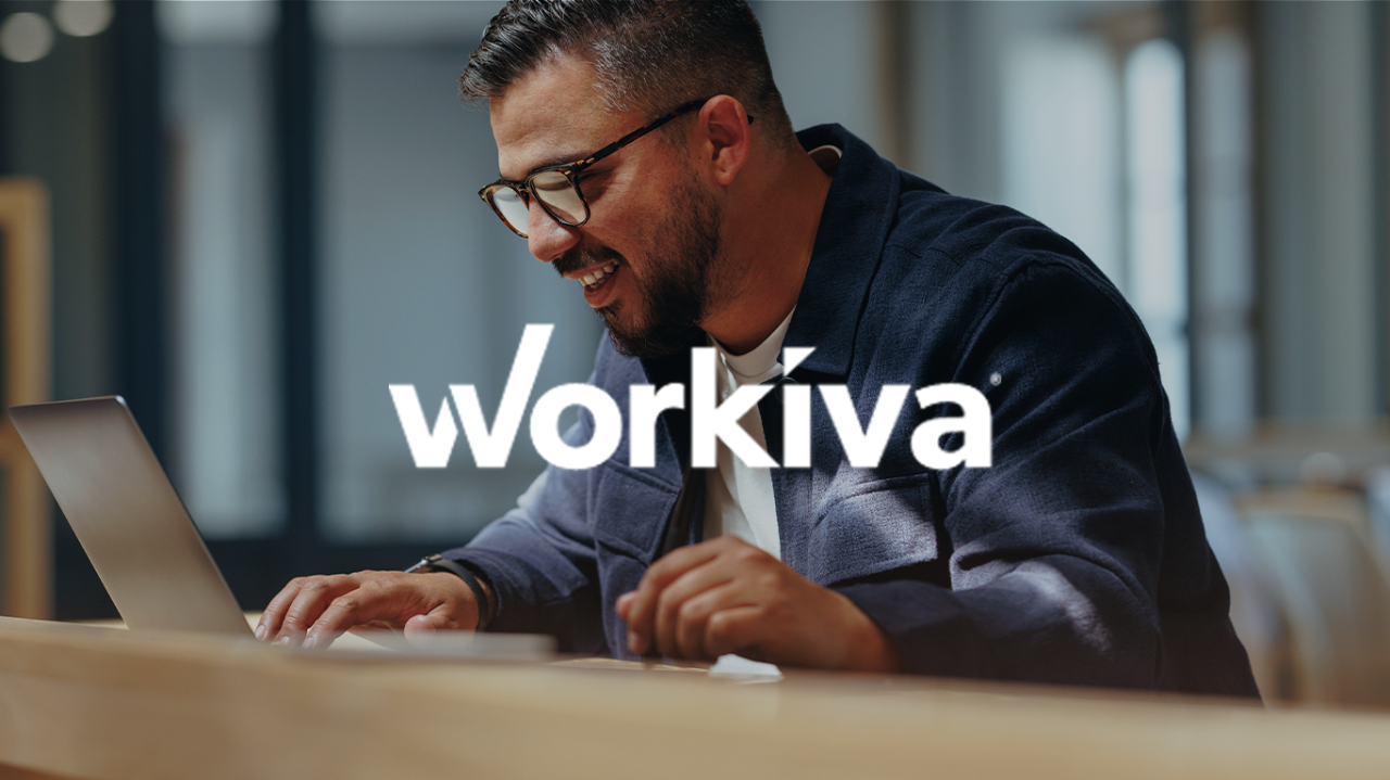 Workiva logo on image of man on laptop